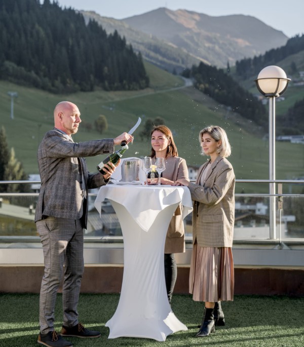 Opening champagne with a saber at the Hotel Alpine Palace