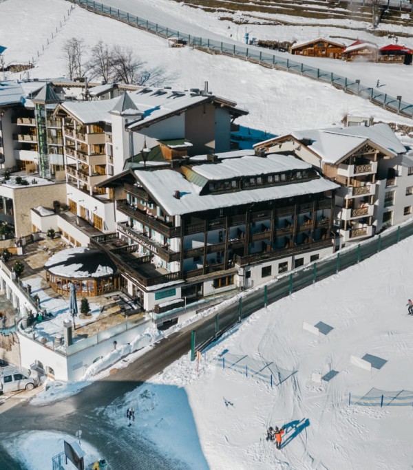 Aerial view from above of the 5 star Hotel Alpine Palace next to the ski slope