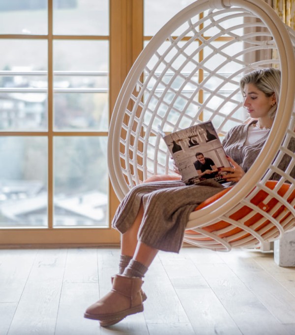 Reading the newspaper in the swing in the room
