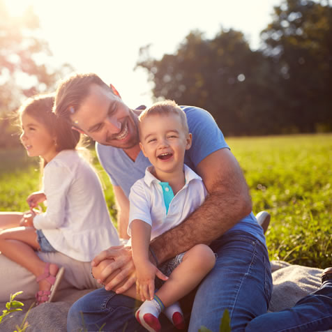 Family sits in the grass